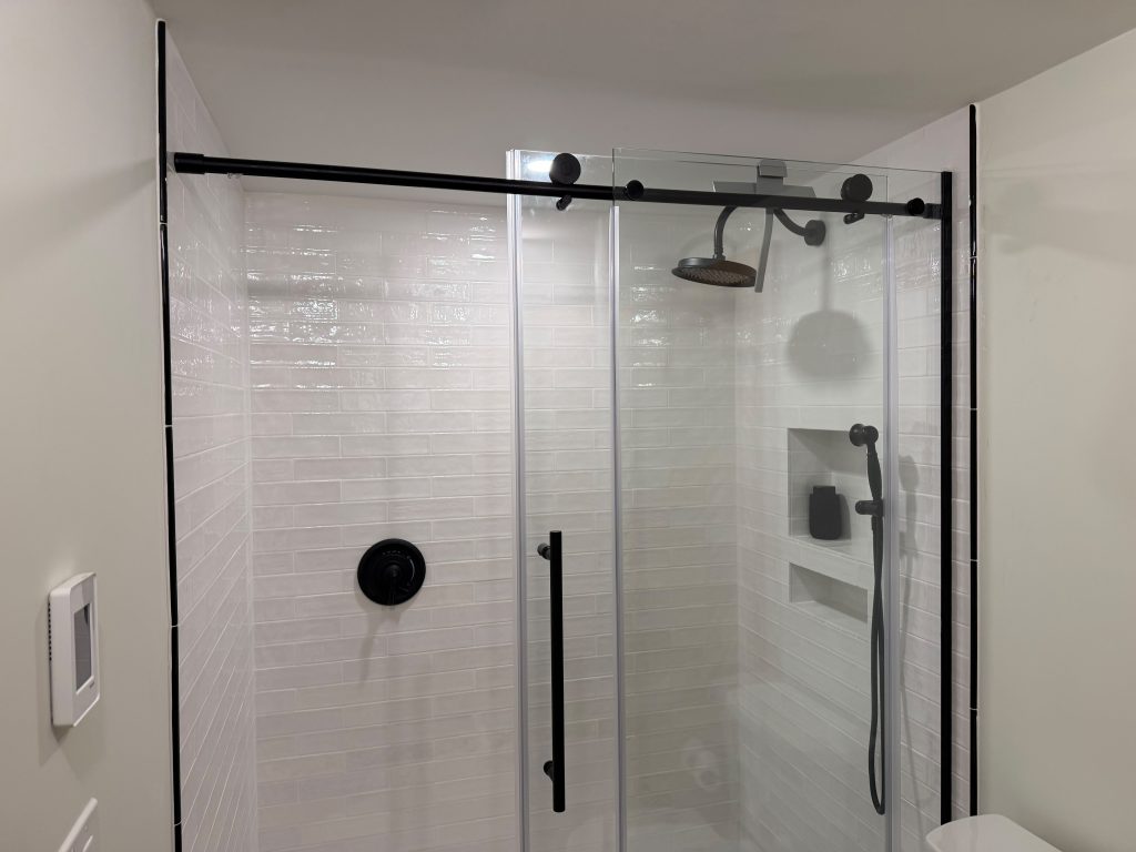 Custom bathroom remodel with large format tile shower and glass enclosure in Massachusetts