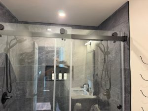 Completed bathroom remodel with custom walk-in shower and glass enclosure by Ronie Construction in Massachusetts