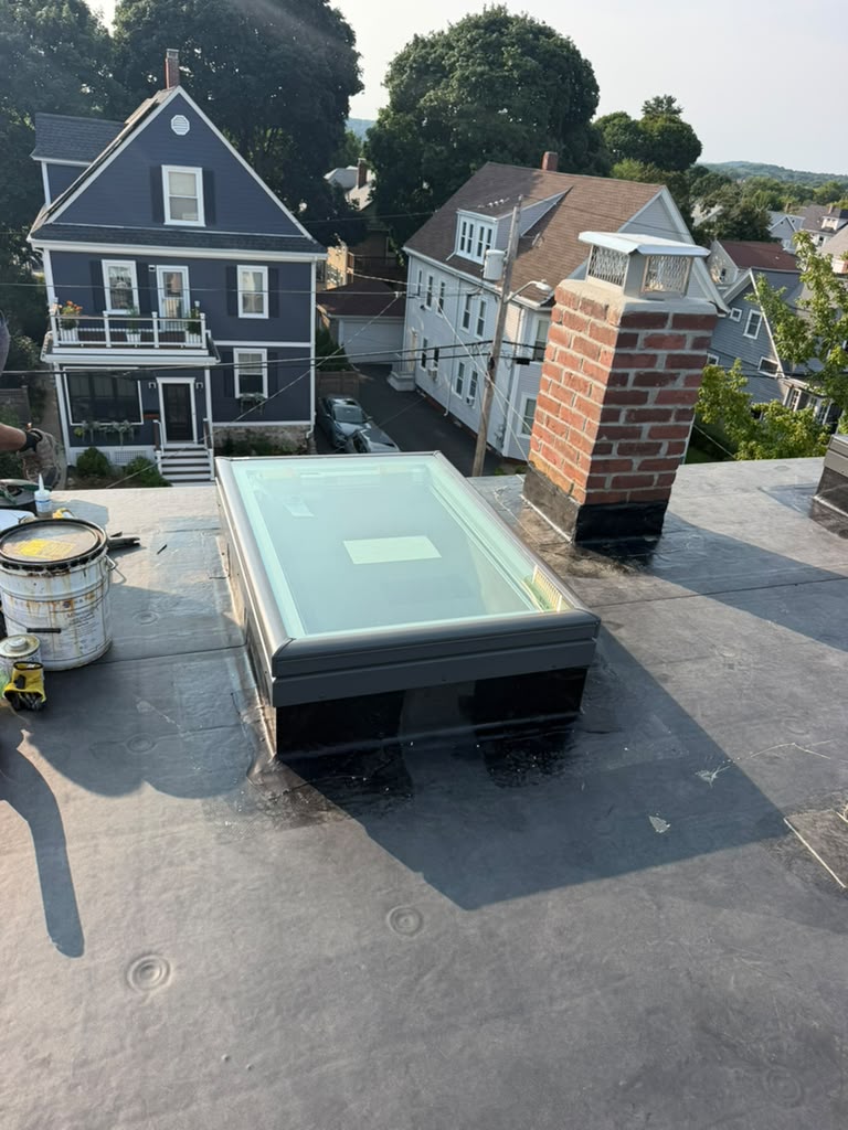 Chimney and roof flashing detail on a flat roof project by Ronie Construction in Massachusetts