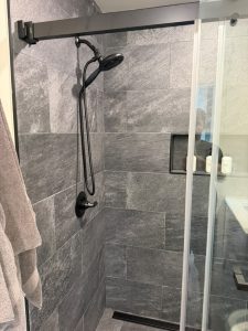 Custom walk-in shower with glass enclosure completed by Ronie Construction in Massachusetts