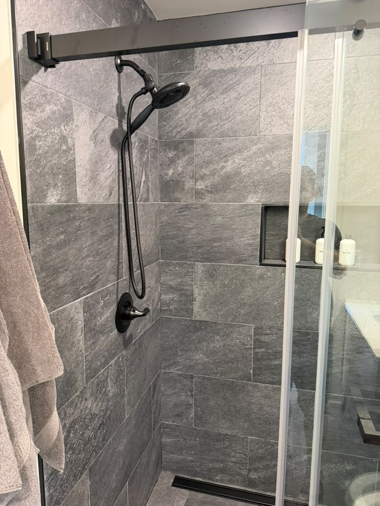 Custom walk-in shower with glass enclosure completed by Ronie Construction in Massachusetts